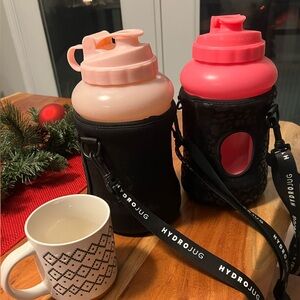 Light Pink HydroJug Water Bottle with Solid Black Sleeve.